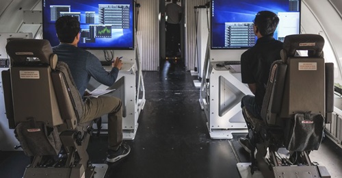 Launch engineers monitor data screens on Cosmic Girl's flight deck