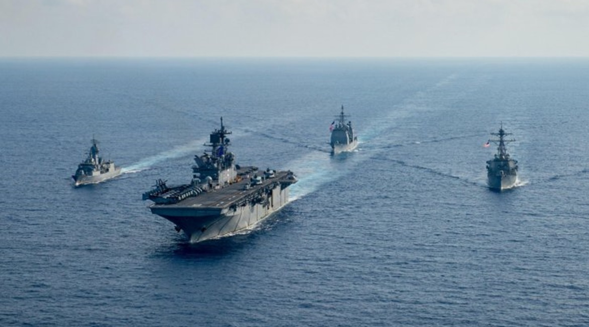 RAN guided-missile frigate HMAS 
        
         (FFH 154), left, sails with USN amphibious assault ship USS 
        
         (LHA 6), guided-missile cruiser USS 
        
         (CG 52) and guided-missile destroyer USS 
        
       ...