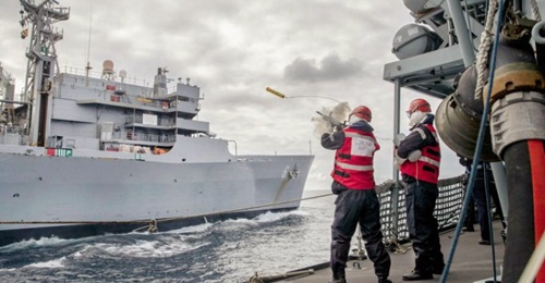 HMS 
        
         practising replenishment at sea with the USNS