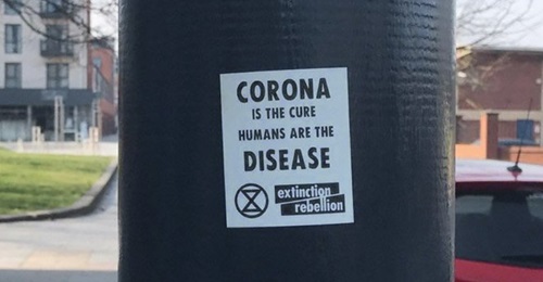 An image of a fake Extinction Rebellion sticker with a message on the Covid-19 pandemic that conveys eco-fascist themes, that was posted by a now-suspended Twitter account. The stickers were left on lampposts in Bedford and Brighton.