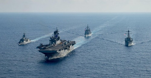 RAN guided-missile frigate HMAS 
        
         (FFH 154), left, sails with USN amphibious assault ship USS 
        
         (LHA 6), guided-missile cruiser USS 
        
         (CG 52), and guided-missile destroyer USS 
        
      ...