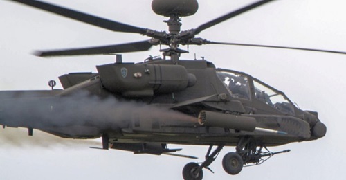 An Apache helicopter launching a Hydra 70 rocket. This weapon can be used as either an unguided air-to-surface munition or with the APKWS kit as a laser-guided munition.