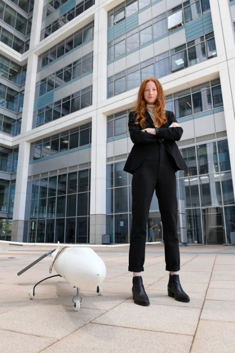 Neta Blum, the head of the Israeli MoD’s Flight Technologies Department, standing next to the SkysPrinter. (Israeli MoD)