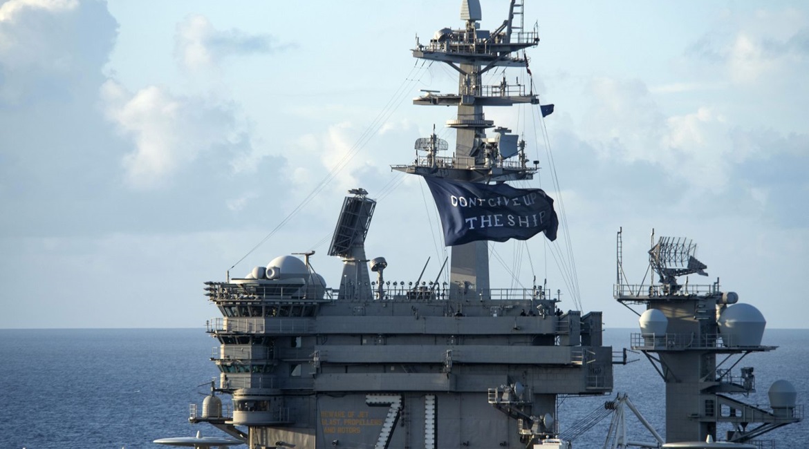 The aircraft carrier USS 
        
         (CVN 71) flies a 'Don't give up the ship' flag as it gets underway following a Covid-19 outbreak.