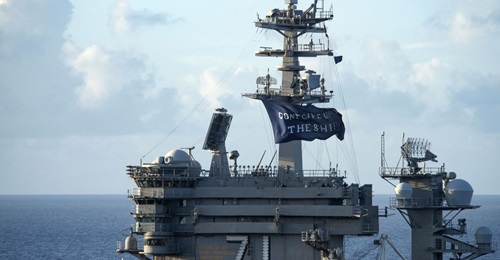 The aircraft carrier USS 
        
         (CVN 71) flies a 'Don't give up the ship' flag as it gets underway following a Covid-19 outbreak.