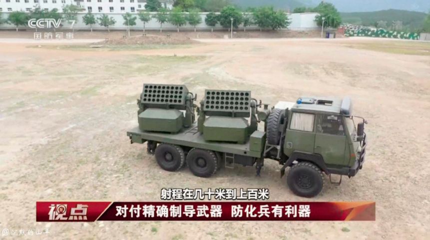 A screengrab from CCTV-7 footage showing a new Chinese truck-mounted countermeasures system capable of launching rockets deploying obscurants and decoys. (CCTV-7)