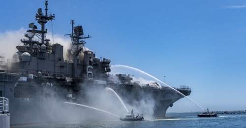 Port of San Diego Harbor Police Department boats combat a fire on board USS 
        
         (LHD 6) at Naval Base San Diego on 12 July.