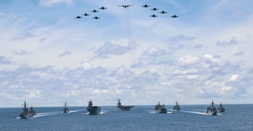 As aircraft from Carrier Air Wing 5 fly overhead, US Navy ships USS 
        
        , 
        
         and 
        
        are seen here on 21 July taking part in a trilateral passage in the Philippine Sea with Royal Australian Navy ship...
