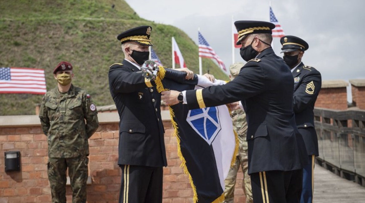 US Army chief of staff Gen James McConville (left) and V Corps commander Lt Gen John Kolasheski (right) unfurl the V Corps flag at Kosciuszko Mound in Krakow, Poland, on 4 August.