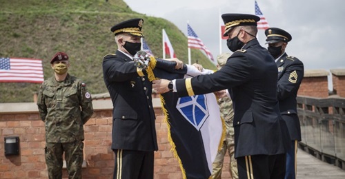 US Army chief of staff Gen James McConville (left) and V Corps commander Lt Gen John Kolasheski (right) unfurl the V Corps flag at Kosciuszko Mound in Krakow, Poland, on 4 August.
