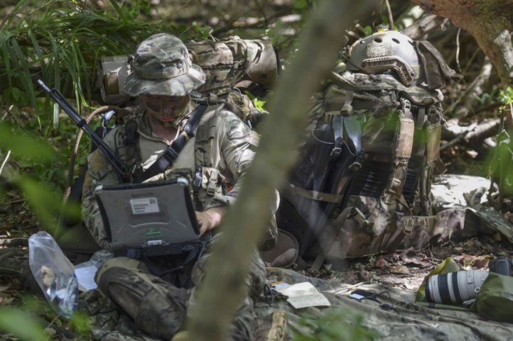 A US Air Force Special Operations Weather Technician sends intelligence to the Reconnaissance Operations Center during the US Marine' Corps Reconnaissance Team Leader Course's final exercise on 31 October, 2017. SOCOM is soliciting industry proposals to improve its Global Analytics Platform to process, exploit and disseminate battlefield intelligence.  (Credit: US Department of Defense )
