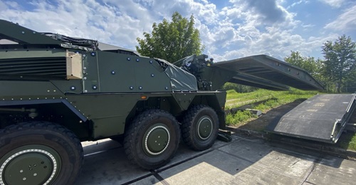 A Boxer fitted with rear mission module launching a Leguan 14 m bridge to Military Load Class 80 over the rear of the platform.