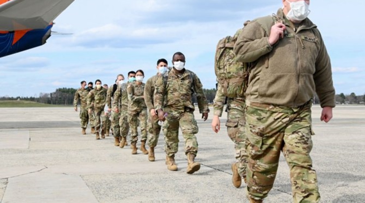 US Army Reserve Soldiers assigned to Urban Augmentation Medical Task Forces arrive at Hanscom Air Force Base, Massachusetts on 17 April, 2020. Officials with the Pentagon's National Geospatial Intelligence Agency are developing a predictive analysis pr...