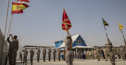Spanish soldiers serving with the coalition lower their flag at the Besmayah Range Complex as they hand the facility over to the Iraqi Army on 25 July. CJTF-OIR attributed this and other base transfers this year to the success Iraqi forces have had aga...