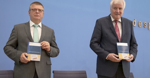 German Federal Minister of the Interior Horst Seehofer (right) and Thomas Haldenwang, president of the Federal Office for the Protection of the Constitution (Bundesamt für Verfassungsschutz: BfV), attend a news conference on 9 July 2020 in Berlin,...