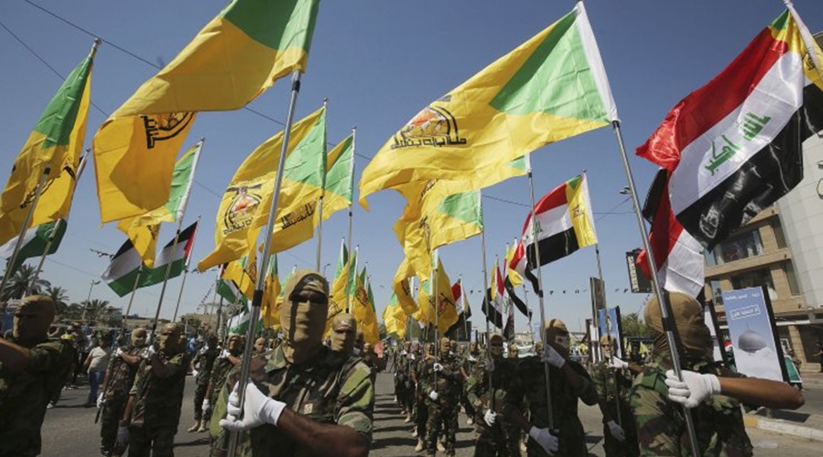 Masked Kataib Hizbullah fighters parade in Baghdad in May 2019.