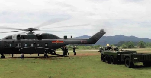 A screengrab from CCTV footage showing the wide-body variant of the CAIG Z-8G medium-lift helicopter shortly before undertaking load-carrying trials with the all-terrain vehicle seen next to it.