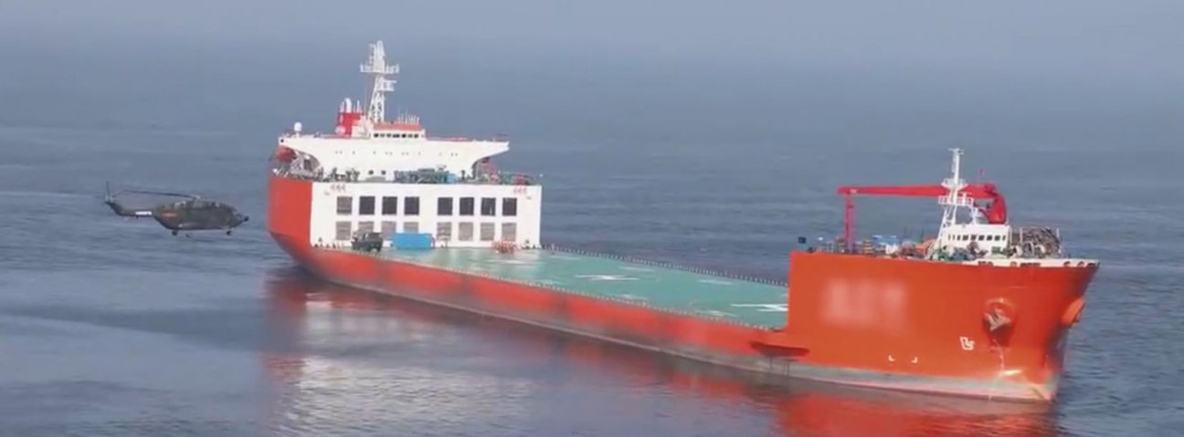 A screengrab from CCTV 7 footage released on 19 August showing a PLAGF Z-8 helicopter about to land on a commercial semi-submersible heavy-lift ship. (CCTV 7 via js7tv.cn)