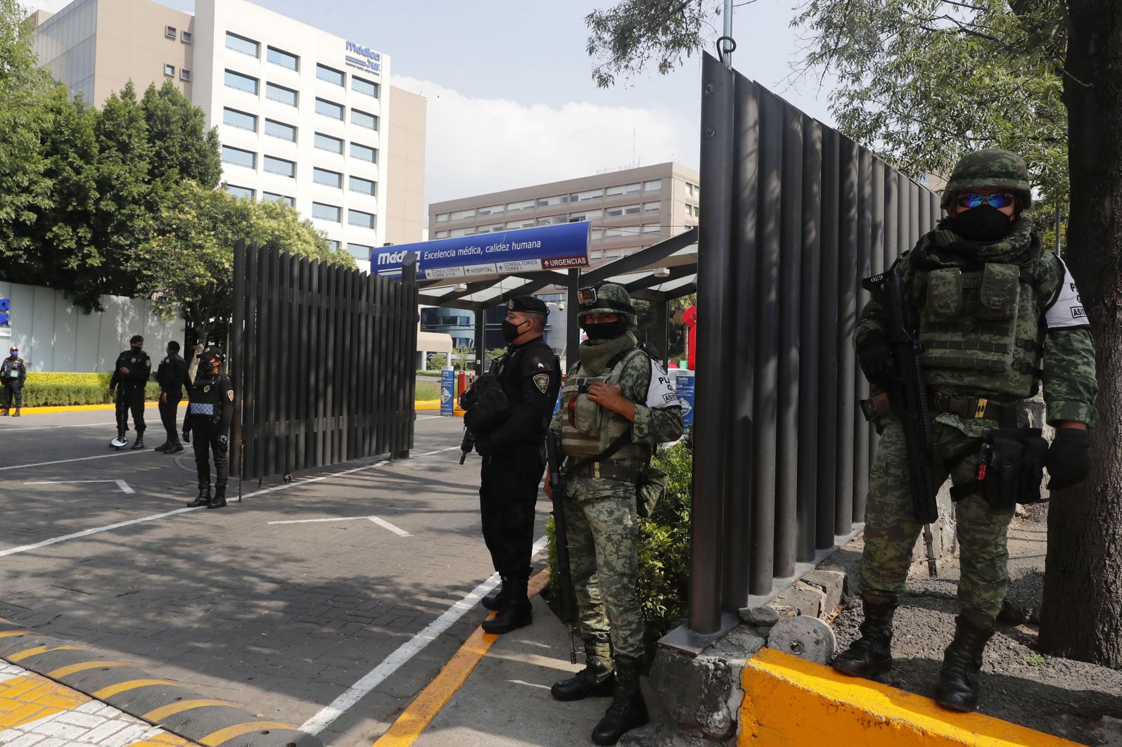 Mexican military troops and police officers guard the Médica Sur Hospital on 30 June 2020, where Mexico City's chief of police, Omar García Harfuch, was hospitalised after an assassination attempt by the Cártel de Jalisco Nueva Generación (CJNG). This was the most high-profile attack by the cartel, a sign of its increasing boldness in the face of the security forces. (Juan Carlos Williams/Eyepix Group/Barcroft Media via Getty Images)