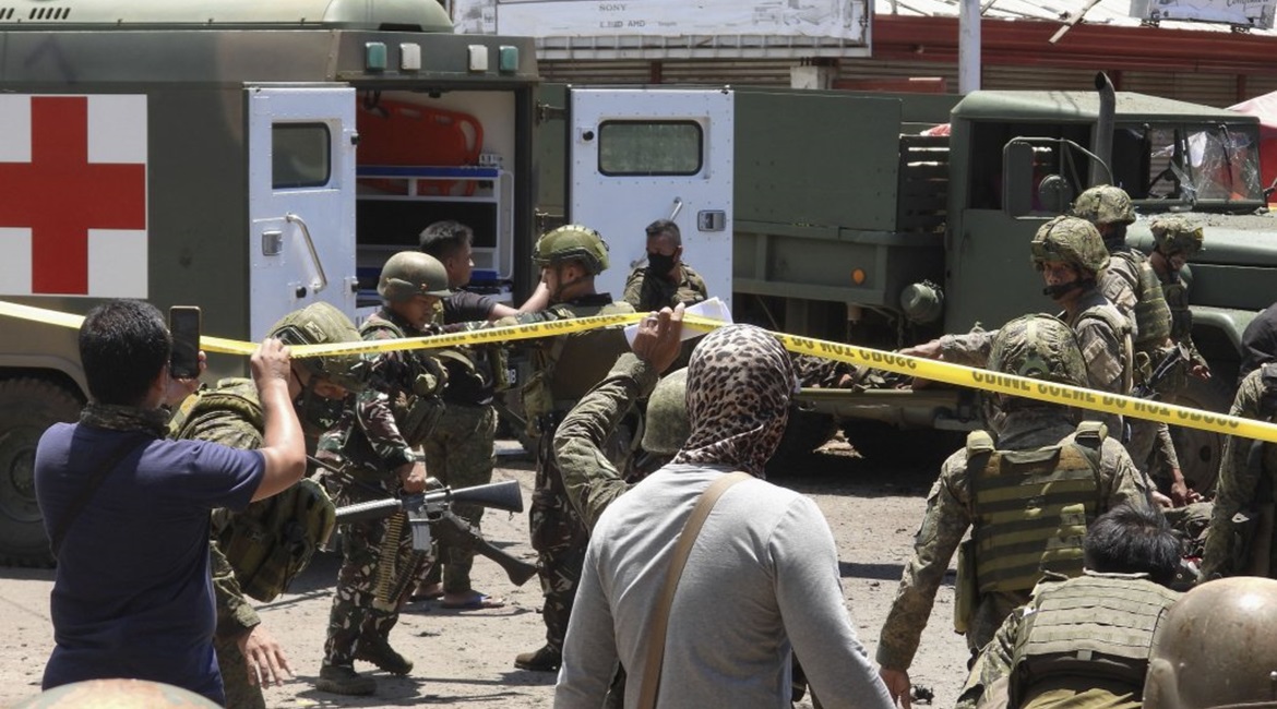 Security forces surround the area near the Barangay Walled City after two female militants conducted a co-ordinated IED attack in Jolo in the Philippines' Solo province on 24 August.