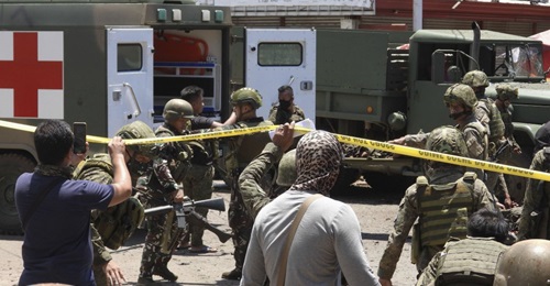 Security forces surround the area near the Barangay Walled City after two female militants conducted a co-ordinated IED attack in Jolo in the Philippines' Solo province on 24 August.