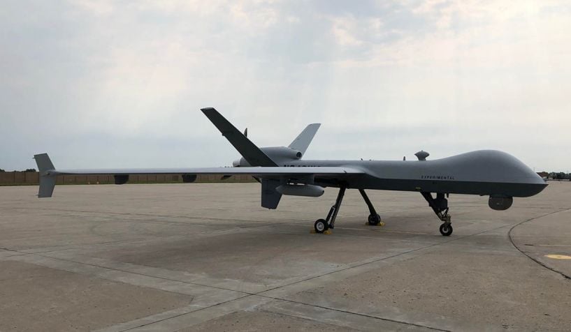 A US Air Force MQ-9 Reaper UAS, equipped with Air Force Research Laboratory’s Agile Condor high-power computing pod, sits on the runway of General Atomics’ Flight Test and Training Center in Grand Forks, North Dakota. The Pentagon’s Joint Artificial Intelligence Center supported the programme’s development via its Smart Sensor initiative. (General Atomics )