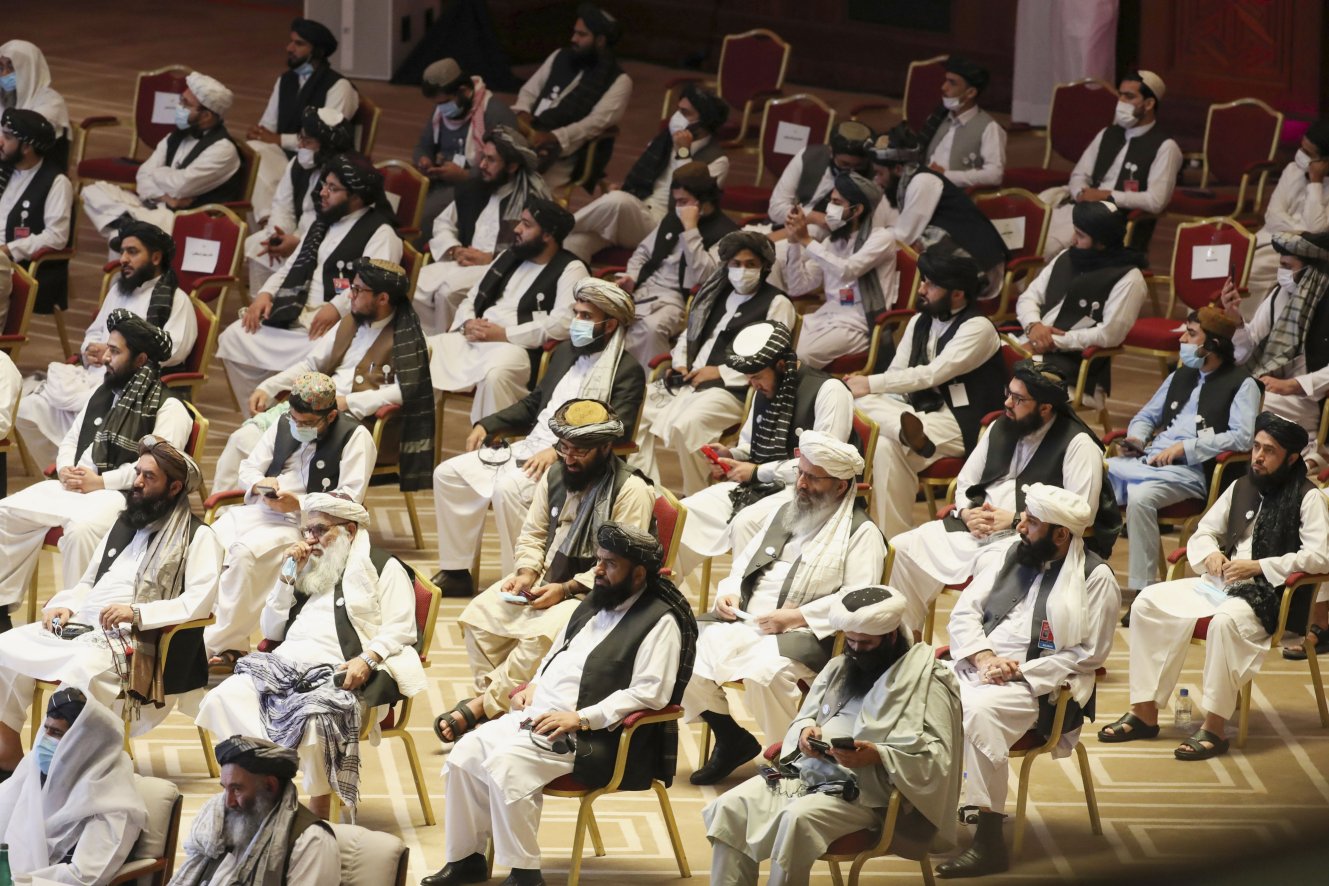 Members of the Taliban delegation attend the opening session of the peace talks between the Afghan government and the Taliban in the Qatari capital Doha on 12 September 2020. Both the likelihood and timing of a complete US troop withdrawal from Afghanistan remain uncertain. (Karim Jaafar/AFP via Getty Images)