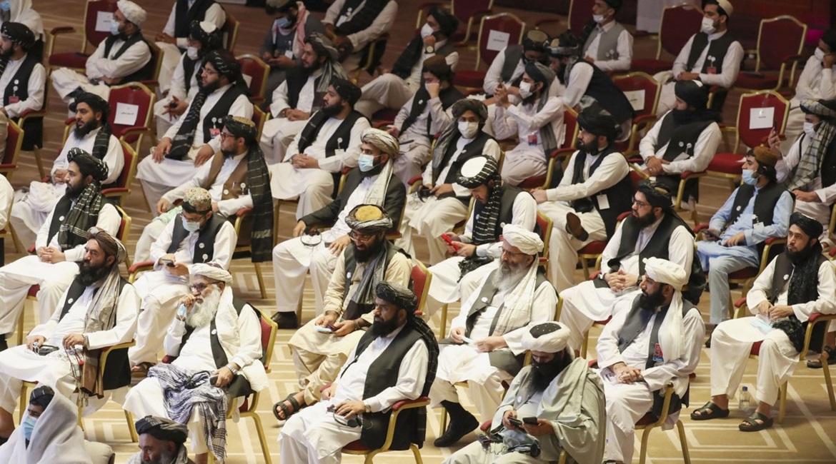 Members of the Taliban delegation attend the opening session of the peace talks between the Afghan government and the Taliban in the Qatari capital Doha on 12 September 2020. Both the likelihood and timing of a complete US troop withdrawal from Afghani...