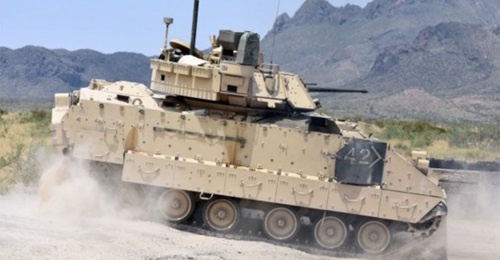 An M2A3 Bradley Fighting Vehicle crew changes position on the range during a gunnery training event in 2018. The US Army plans to issue a final RFP for its revamped Bradley replacement effort in December.