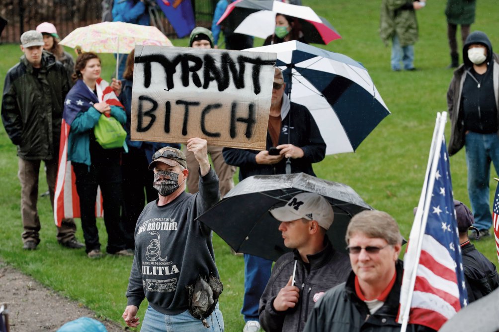 A group of individuals attends an anti-shutdown rally at the Capitol in Lansing in the state of Michigan on 14 May 2020 to protest against Governor Gretchen Whitmer’s Covid-19-related restrictions.  (Getty Images)