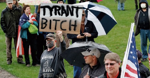 A group of individuals attends an anti-shutdown rally at the Capitol in Lansing in the state of Michigan on 14 May 2020 to protest against Governor Gretchen Whitmer's Covid-19-related restrictions.