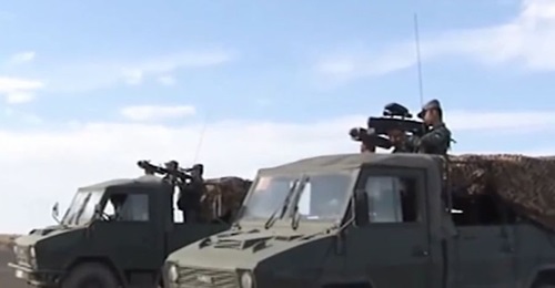 Two of the vehicles used in the exercise. One of the vehicles (foreground) is carrying soldiers equipped with a MANPADS and a handheld jammer while the other is carrying soldiers equipped with a similar MANPADS and what appears to be a net gun.