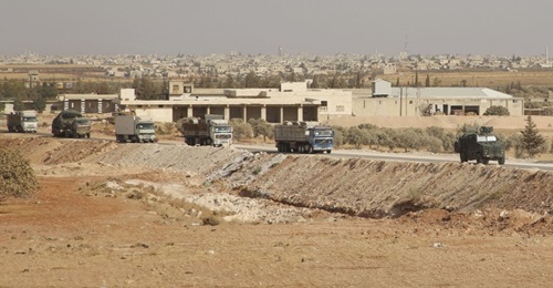 The convoy from the evacuated Turkish outpost east of Morek arrives in rebel-held territory near Al-Nayrab on 20 October.
