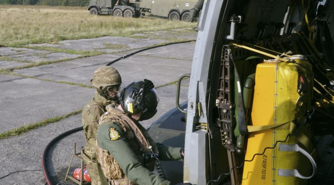 A Merlin crew member and ground support personnel refuel the helicopter during a deployment exercise. The UK MoD is looking to reduce the reliance on fossil fuels for its aircraft fleets as part of a wider UK government drive towards more sustainable f...