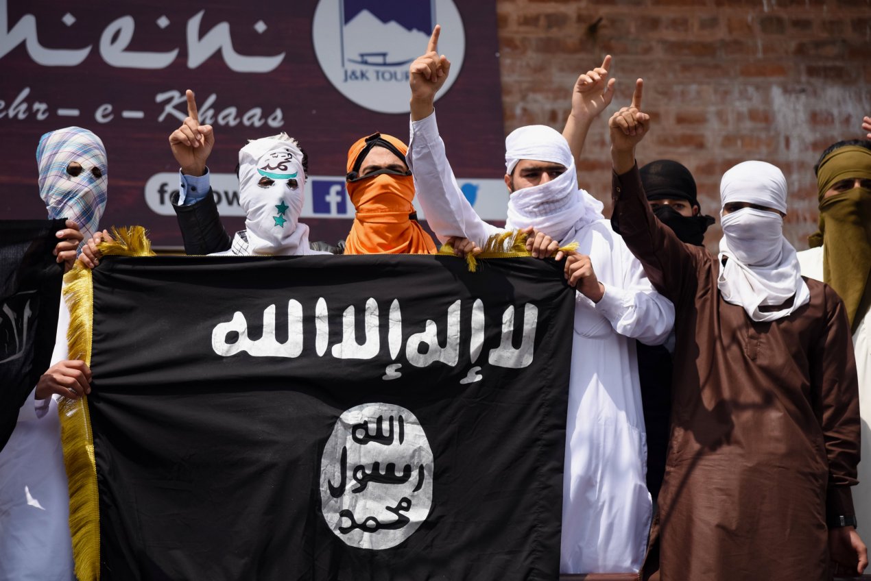 Kashmiri protesters hold up an Islamic State flag in Srinagar in India’s Jammu and Kashmir state on 5 June 2019. Wilayat Pakistan sources claimed that their group and Wilayat al-Hind were actively recruiting in the region. (Idrees Abbas/SOPA Images/LightRocket via Getty Images)