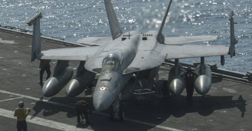Sailors on 28 October 2020 secure a Boeing F/A-18E Super Hornet, from the “Kestrels” of Strike Fighter Squadron (VFA) 137, on the flight deck of the aircraft carrier USS 
        
         (CVN 68). A F/A-18E crash on 20 October wa...