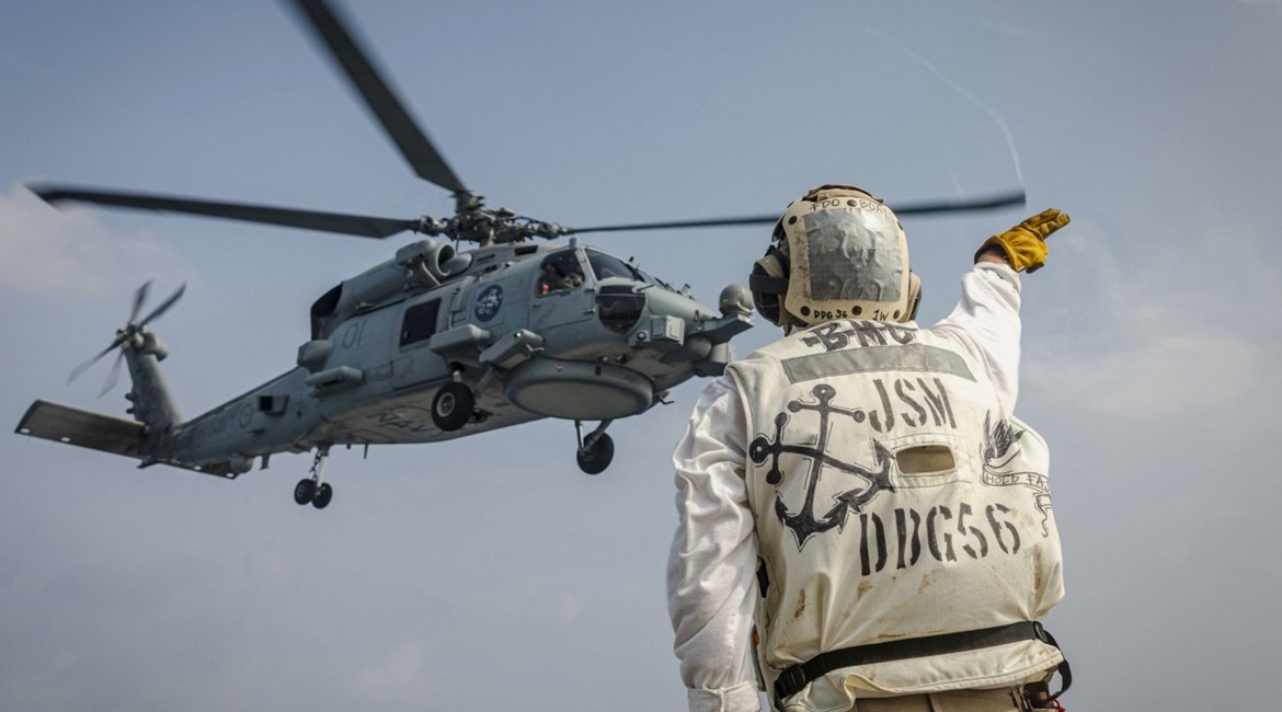 An MH-60R Sea Hawk helicopter from the Royal Australian Navy Anzac-class frigate HMAS Ballarat (FFH 155) takes off from the flight deck of the Arleigh Burke-class guided-missile destroyer USS John S. McCain (DDG 56) as part of 'Malabar 2020'.