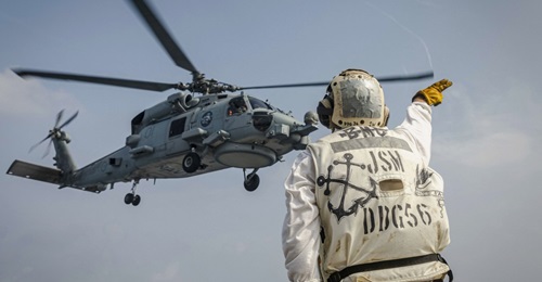 An MH-60R Sea Hawk helicopter from the Royal Australian Navy Anzac-class frigate HMAS Ballarat (FFH 155) takes off from the flight deck of the Arleigh Burke-class guided-missile destroyer USS John S. McCain (DDG 56) as part of 'Malabar 2020'.