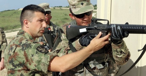 A Serbian military operations in urban terrain (MOUT) instructor trains members of the Ohio National Guard's 838th Military Police Company on 12 June 2019 during peacekeeping exercise 'Platinum Wolf 2019' at South Base, Serbia.
