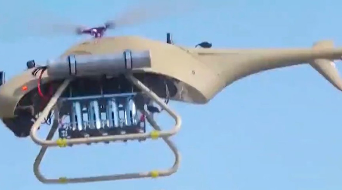 A Ziyan Blowfish A2 VTOL UAV in flight fitted with an underslung rack for four mortar bombs.