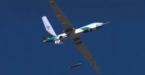 A Wing Loong-series UAV in flight dropping a munition-shaped canister carrying supplies.