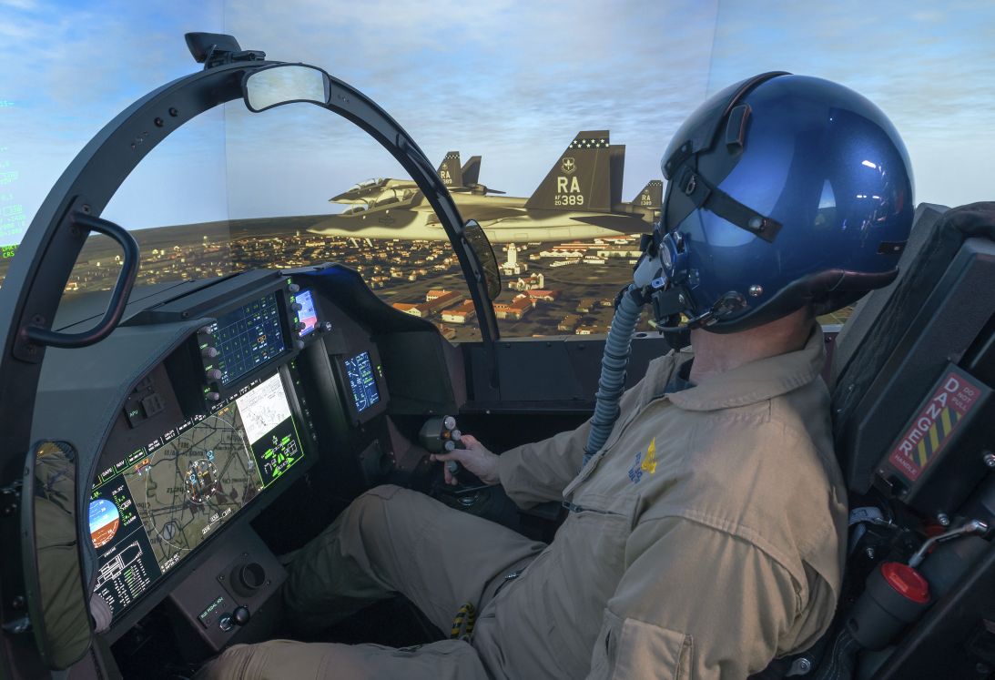 A Boeing test pilot operating the company’s T-7A representative operational flight trainer (OFT). The OFT has a five-channel projection system with a 300° field-of-view. (Boeing)