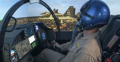 A Boeing test pilot operating the company's T-7A representative operational flight trainer (OFT). The OFT has a five-channel projection system with a 300° field-of-view.