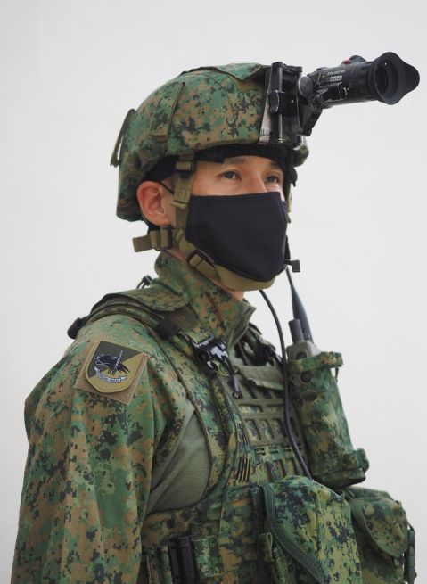 The new load-bearing system comprises the standard and enhanced variants. The enhanced variant, which is being issued to combat units, is seen along with the new high-cut ballistic helmet in this image.  (Janes/Kelvin Wong)