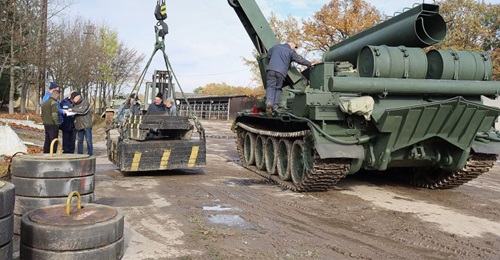 The vehicle is shown demonstrating the lift capacity of its modernised crane.