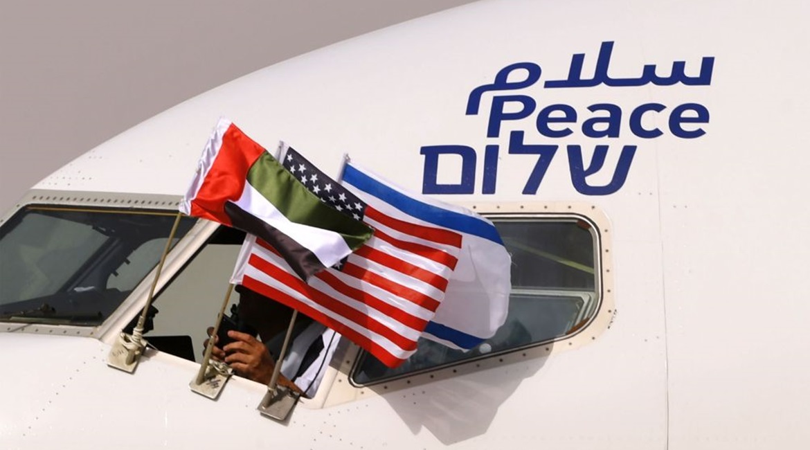 Emirati, Israeli, and US flags are attached to an El-Al aircraft with the word 'peace' written in Arabic, English, and Hebrew. The flight arrived at Abu Dhabi airport - the first commercial flight from Israel to the UAE - on 31 August 2020.