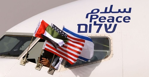 Emirati, Israeli, and US flags are attached to an El-Al aircraft with the word 'peace' written in Arabic, English, and Hebrew. The flight arrived at Abu Dhabi airport - the first commercial flight from Israel to the UAE - on 31 August 2020.