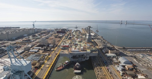 The aircraft carrier 
        
         (CVN 79) is among the ships that Huntington Ingalls Industries is building for the US Navy.