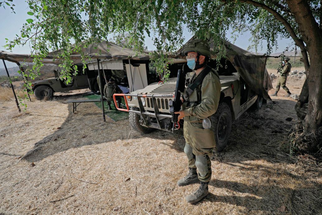 An Israeli soldier stands guard next to an outpost on 27 October 2020 during exercise ‘Deadly Arrow’ simulating a war against Hizbullah as part of efforts to improve the Israeli military’s attack capabilities. The IDF believes that Hizbullah is the number one security threat for Israel in 2021. (Jalaa Marey/AFP via Getty Images)