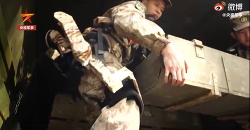 A screengrab from CCTV 7 footage released on 11 January showing a new type of exoskeleton system being used by PLA troops to assist them in carrying ammunition crates.